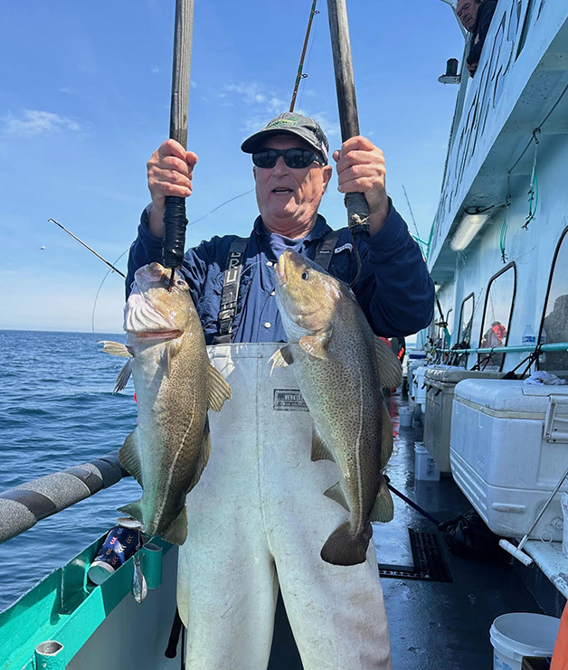 a person holding a fish on a boat