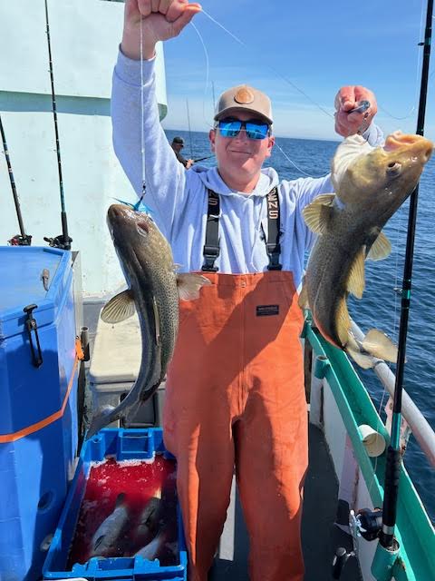 a person holding a fish on a boat