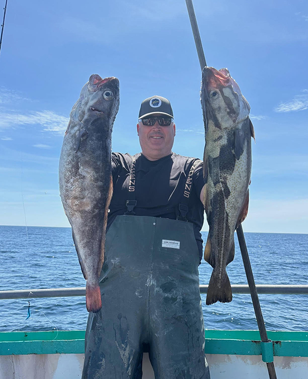 a person holding a fish in the water