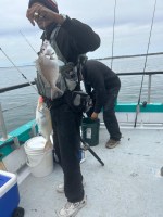 a person holding a fish on a boat