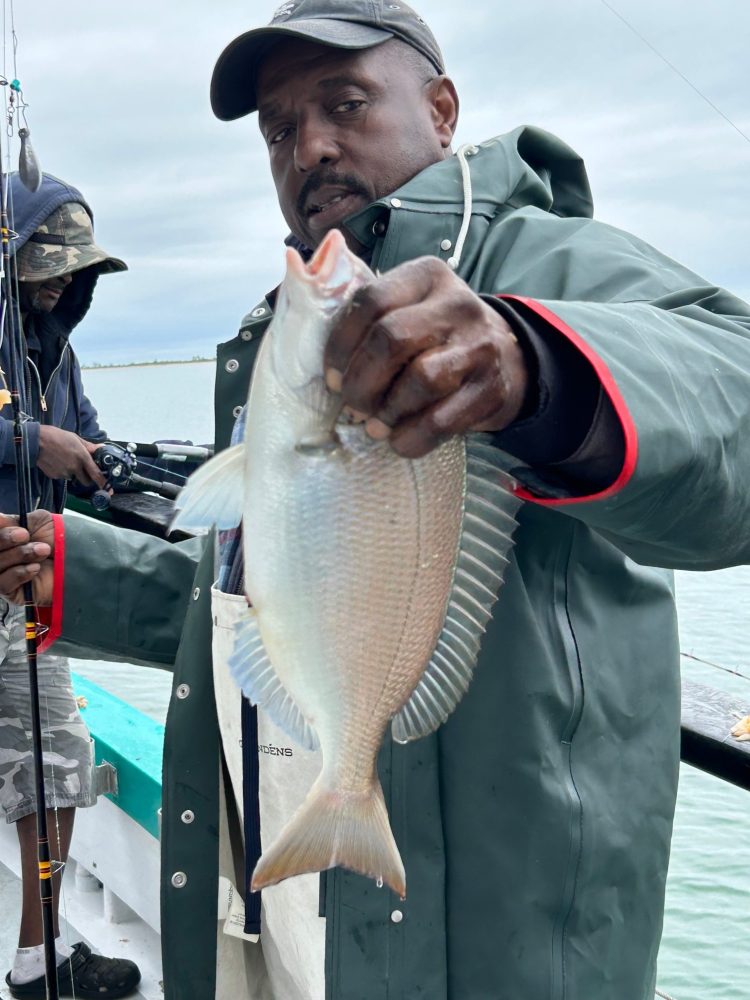 a man holding a fish