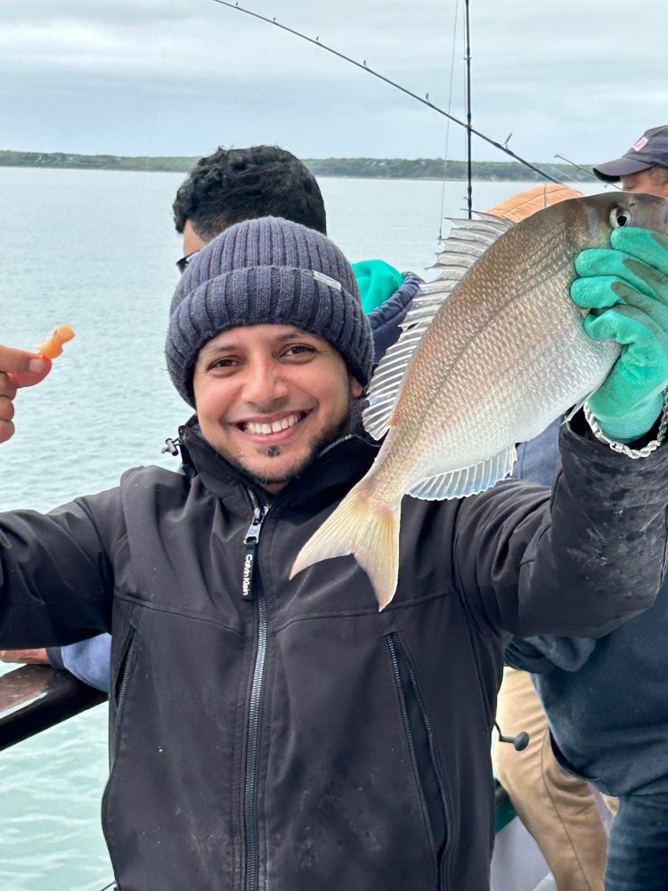 a person holding a fish in the water