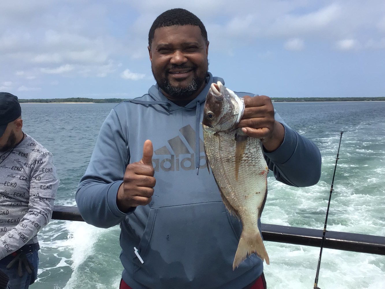 a man holding a fish in the water