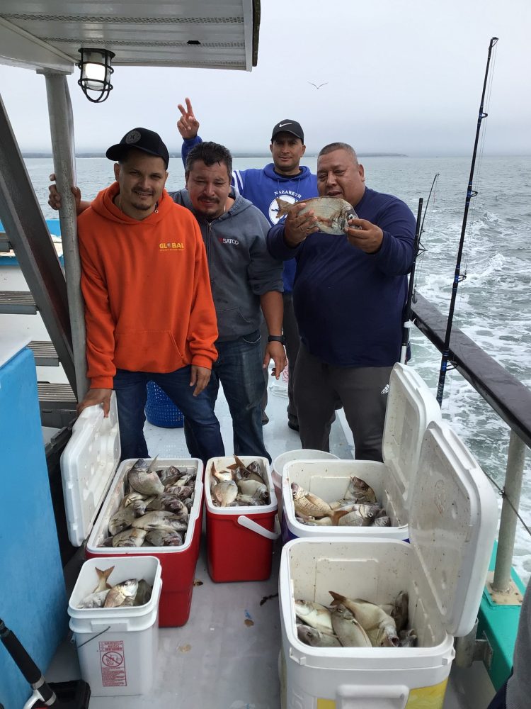 a group of people on a boat posing for the camera