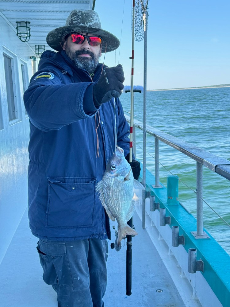 a person holding a fish in the water