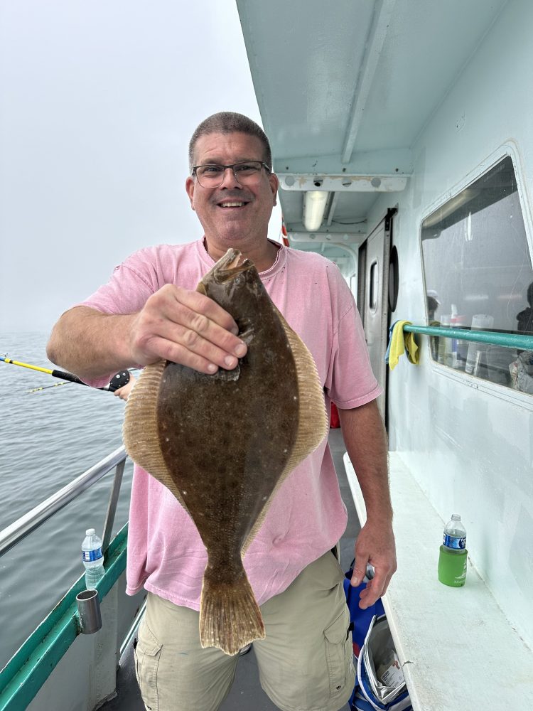 a man holding a fish