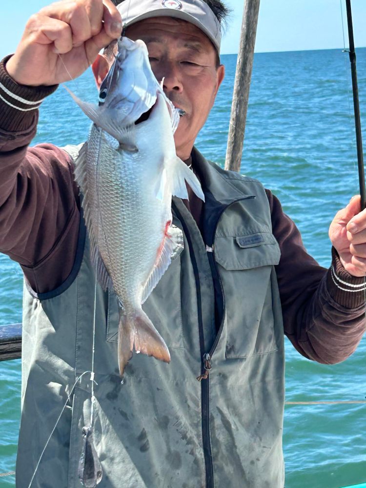 a person holding a fish in the water