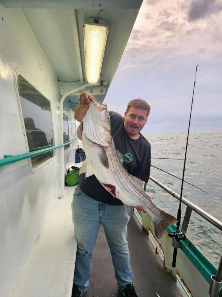 a person holding a fish in the water