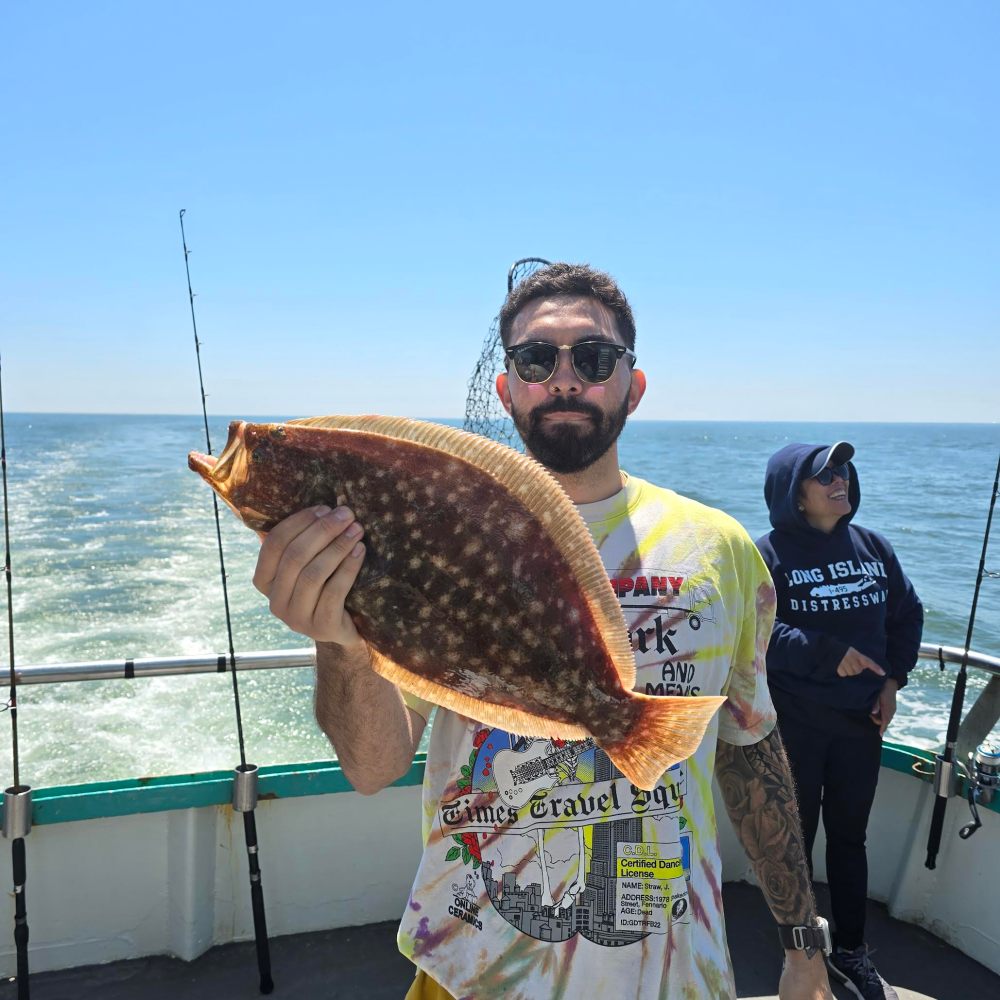 a man holding a fish in the water