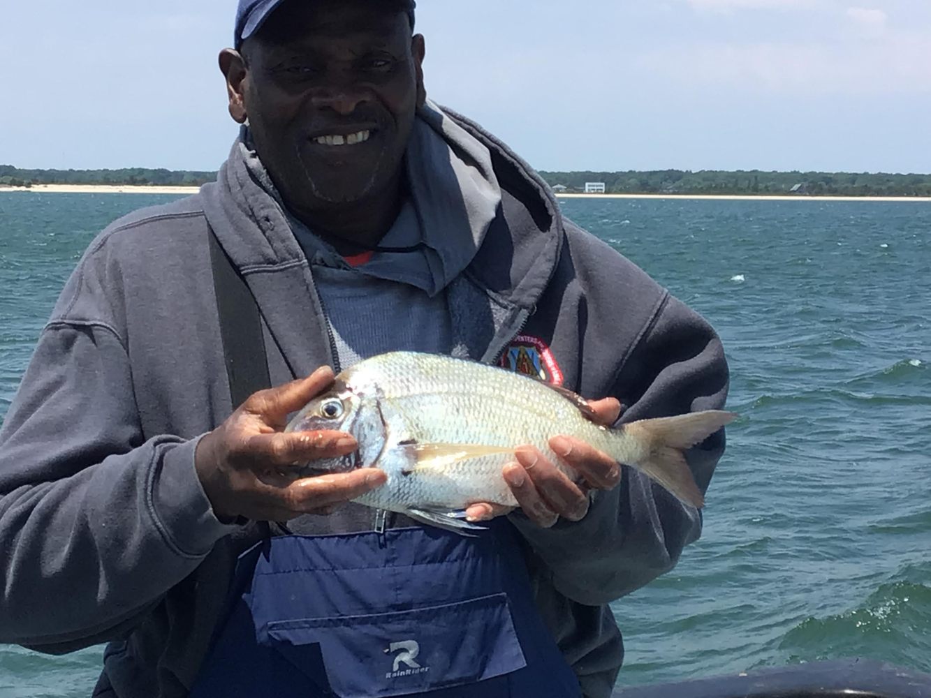 a person holding a fish in the water