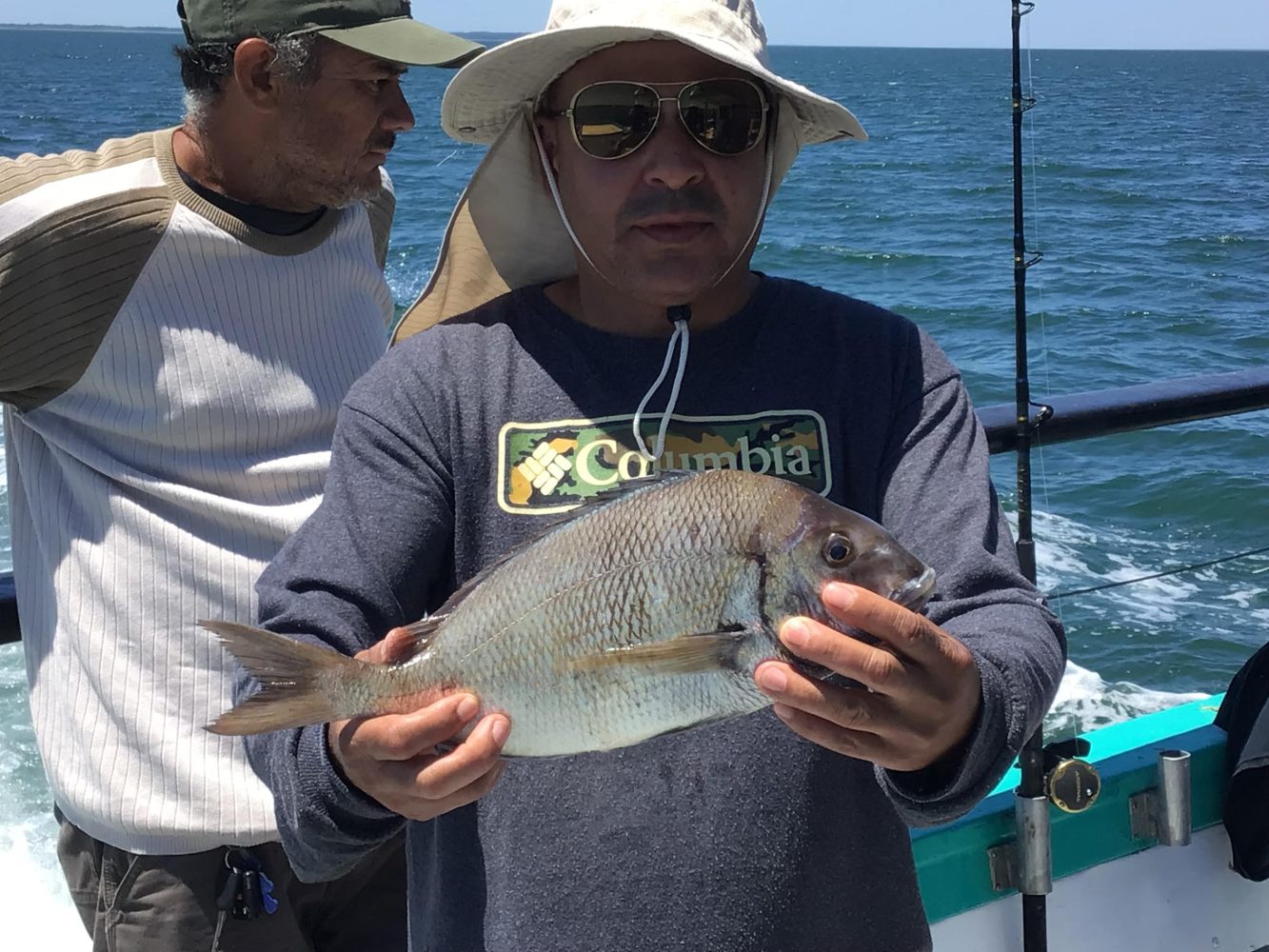 a person holding a fish in the water