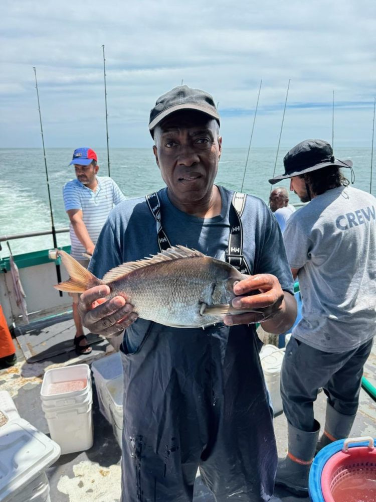 a man holding a fish