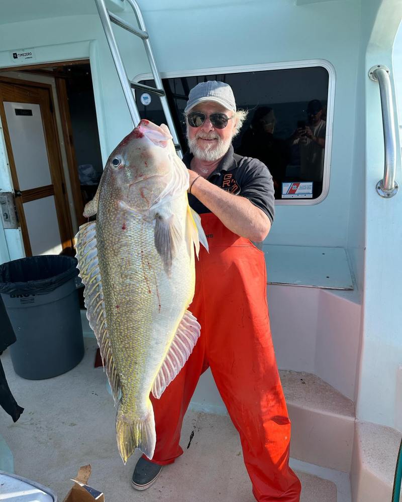 a man holding a fish