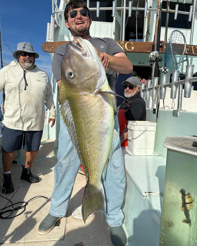 a man holding a fish