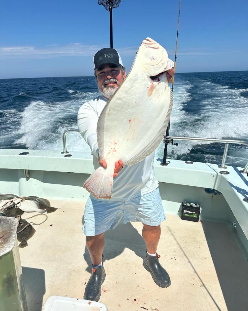 a man holding a fish in the water