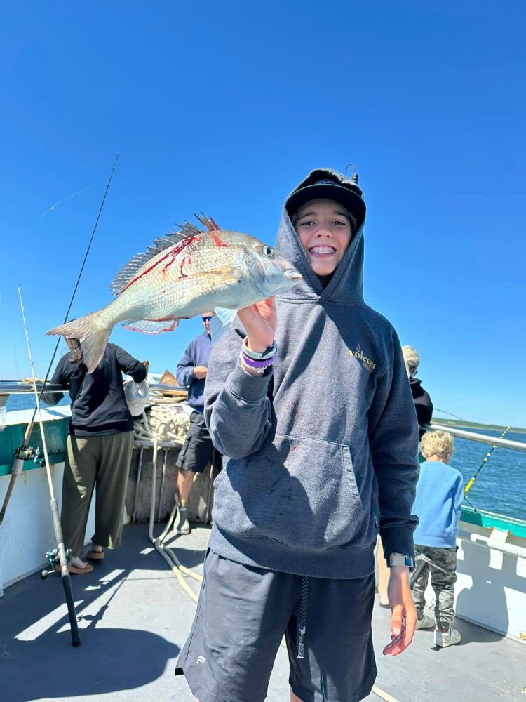 a person holding a fish