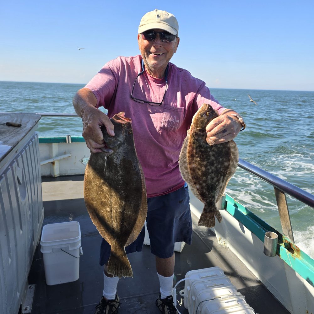 a man holding a fish in the water