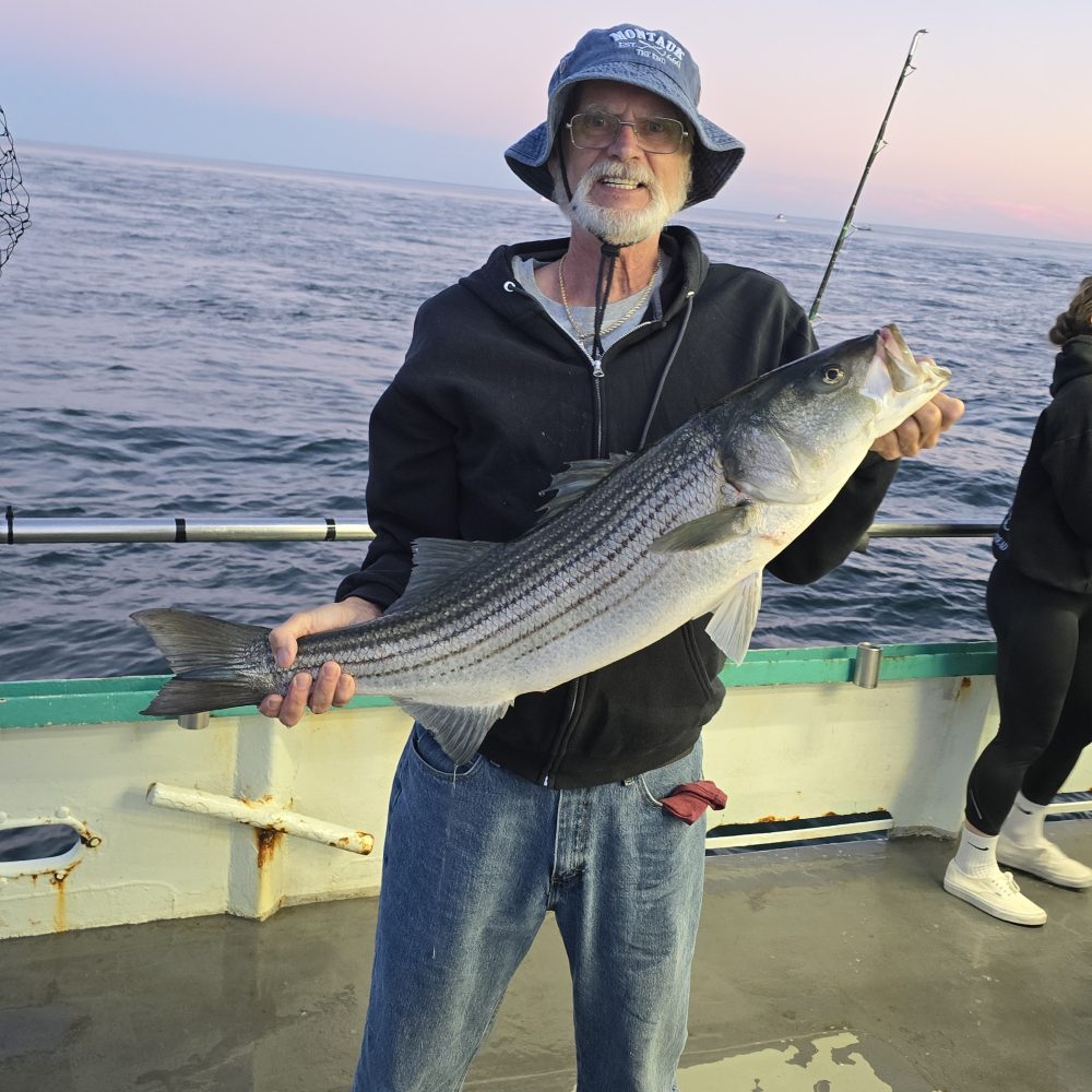 a man holding a fish in the water