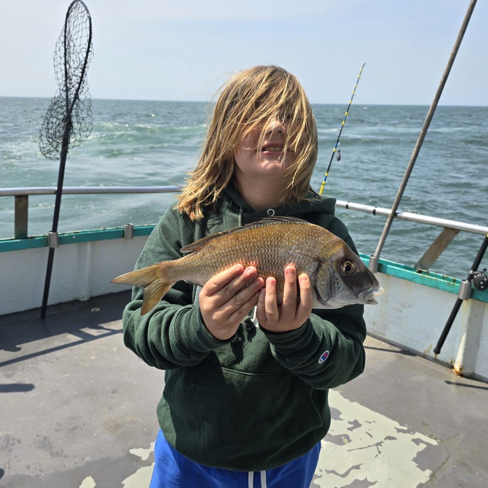 a woman holding a fish in the water