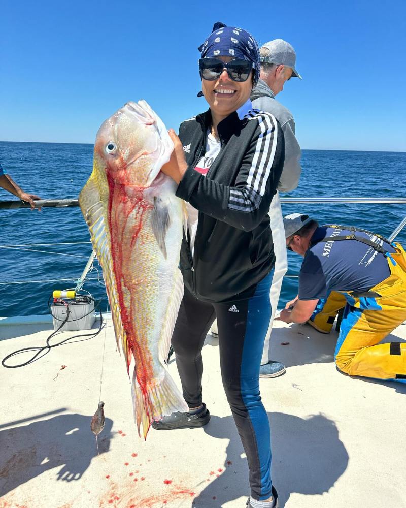 a person holding a fish in the water