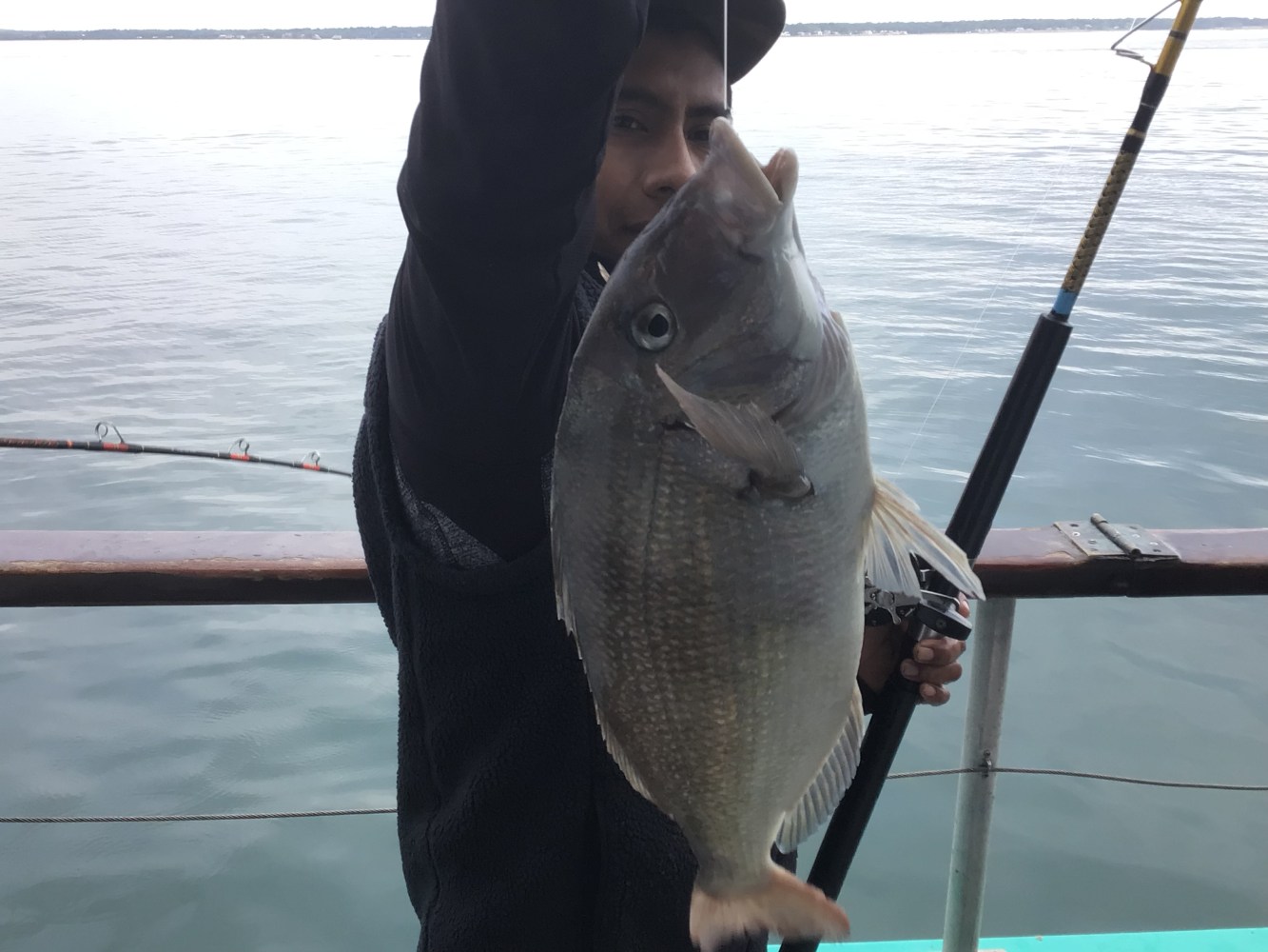 a person holding a fish in the water