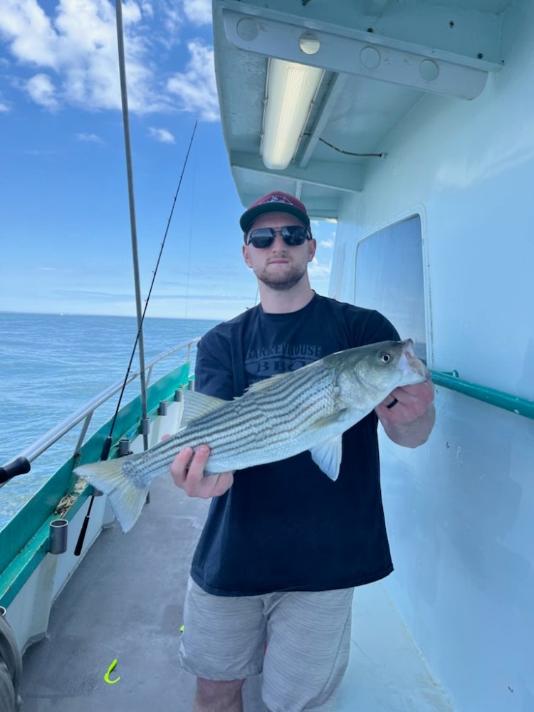 a person holding a fish on a boat