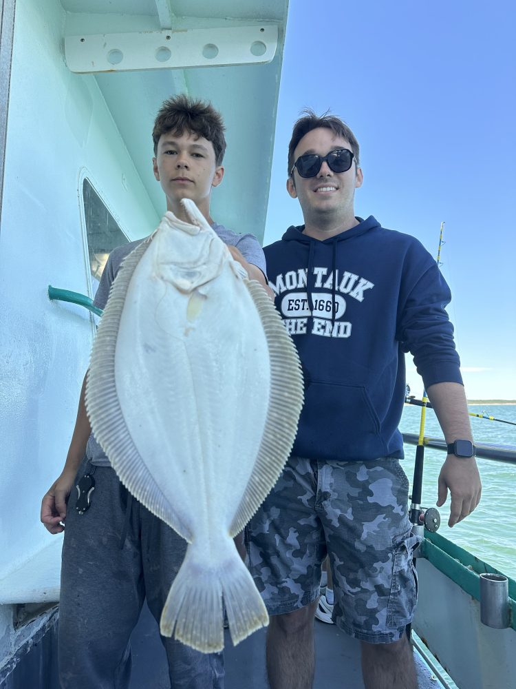 a man holding a fish