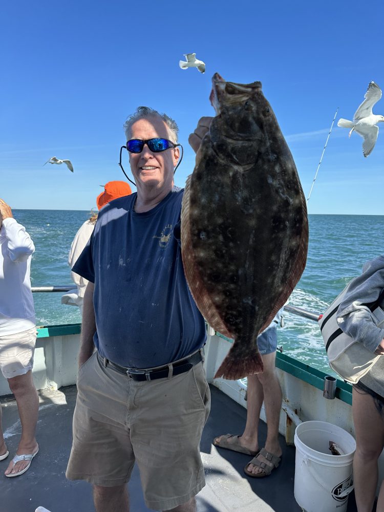 a person holding a fish in the water