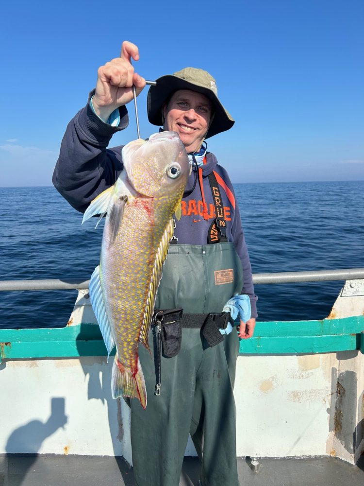 a person holding a fish in the water