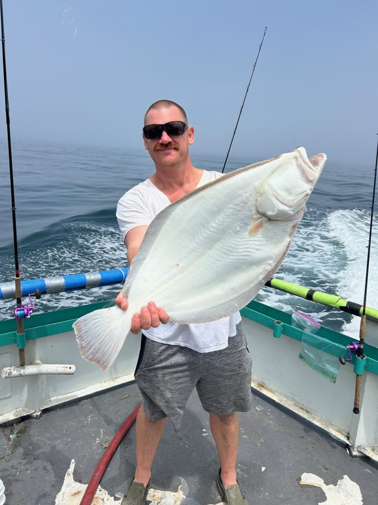 a man holding a fish in the water