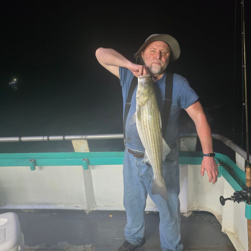 a man holding a fish