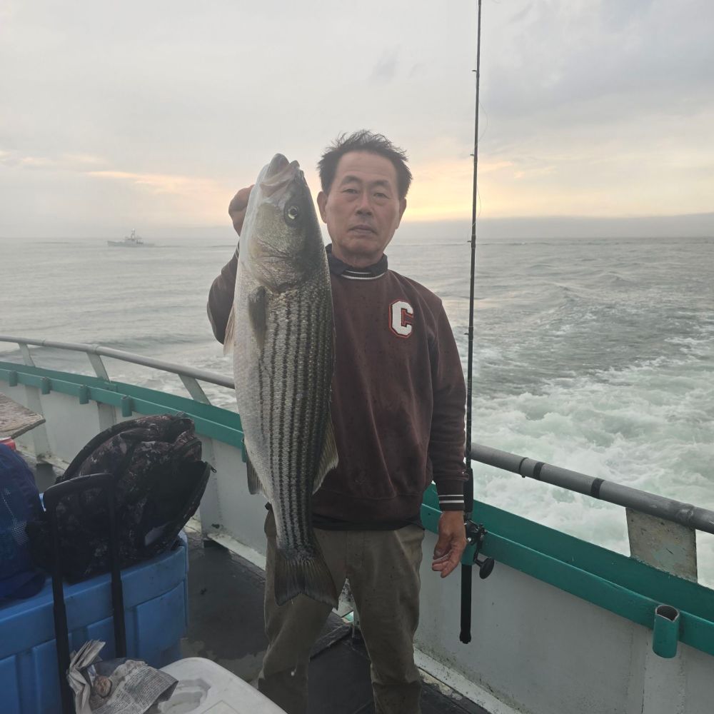 a man holding a fish in the water