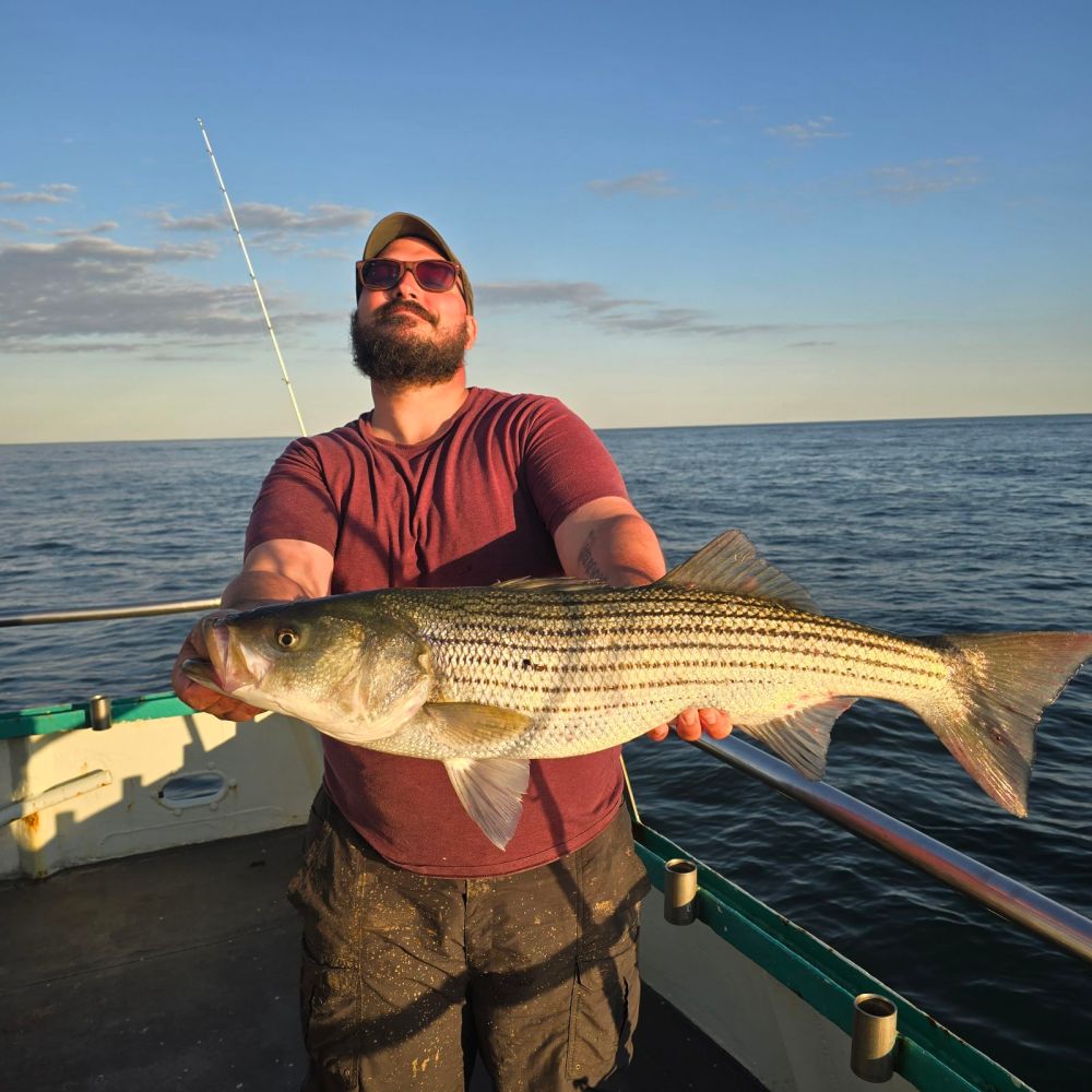 a man holding a fish in the water