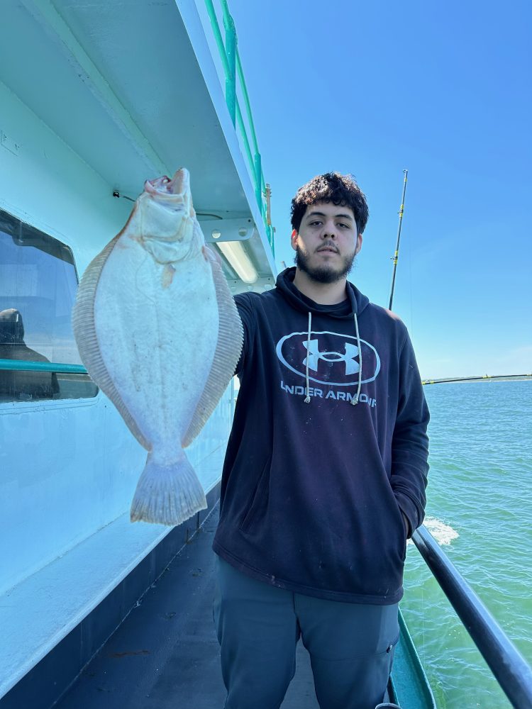 a person standing next to a body of water