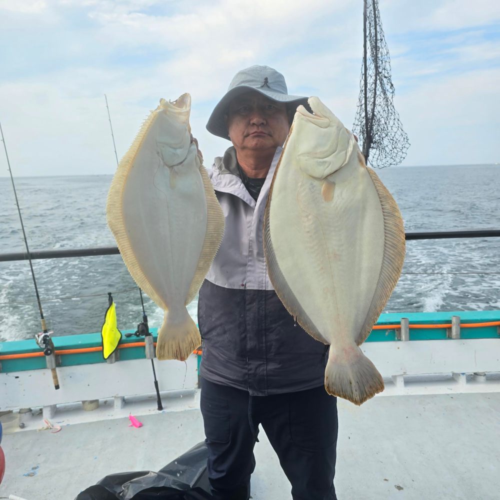 a man holding a fish in the water