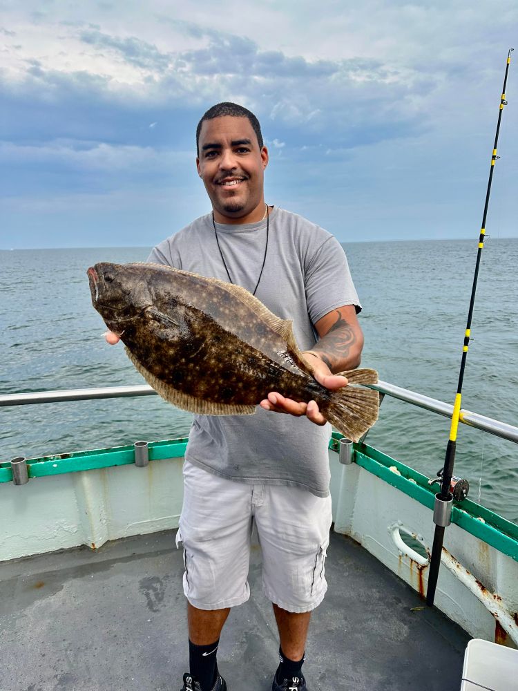 a man holding a fish in the water