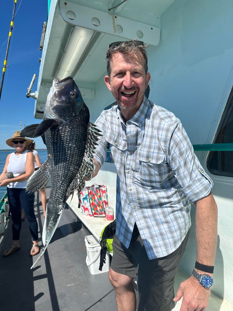 a man holding a fish