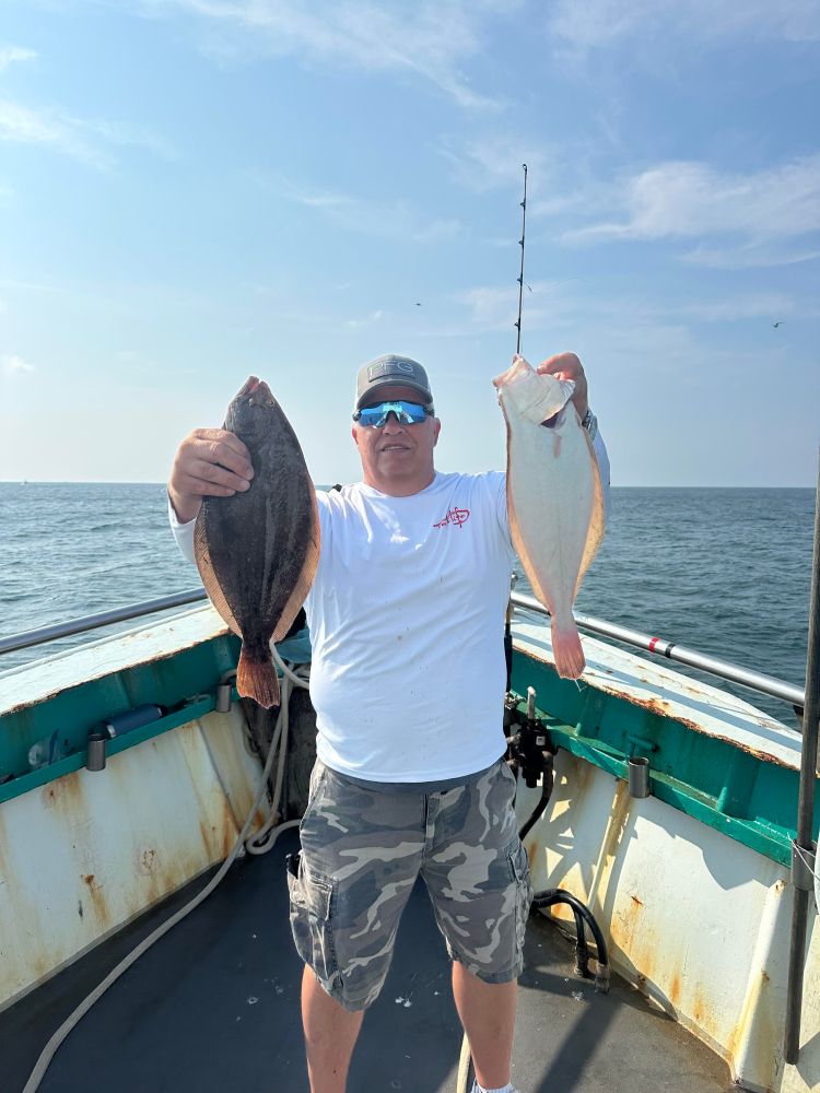 a man holding a fish in the water