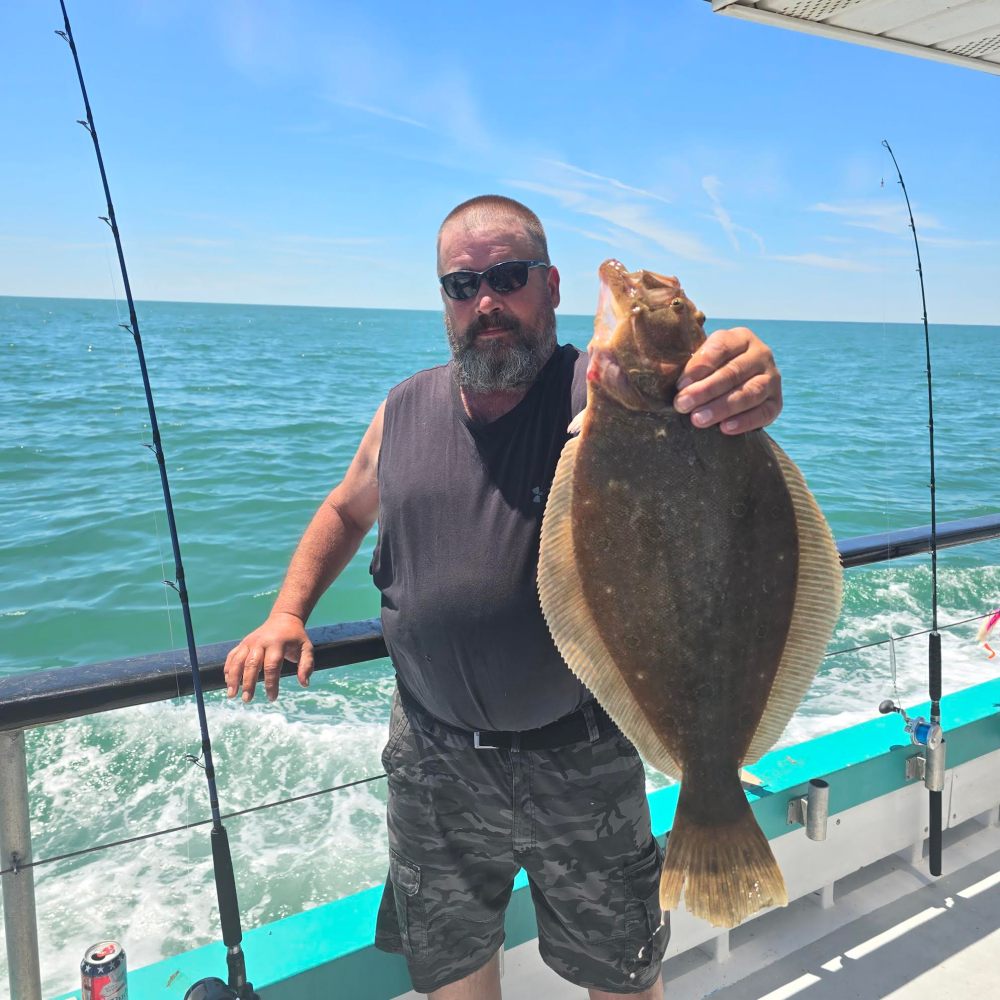 a man holding a fish in the water