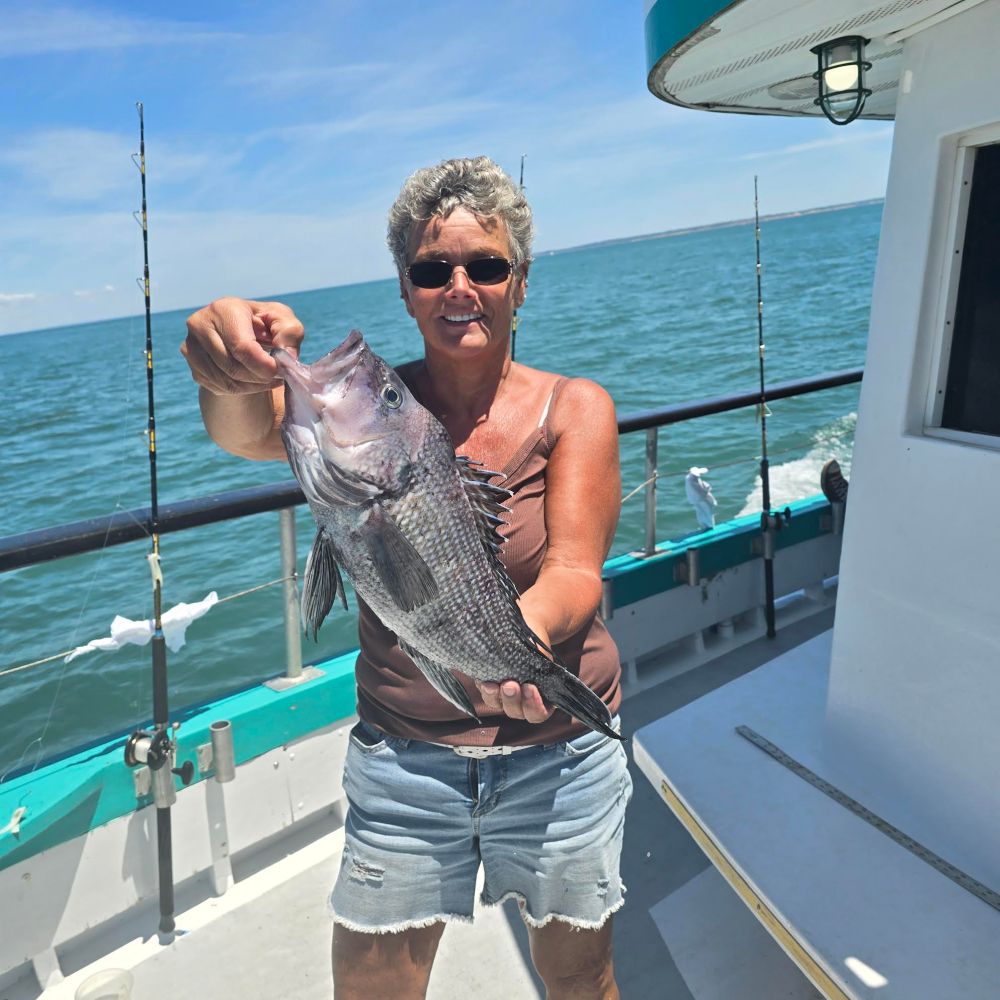 a man holding a fish in the water