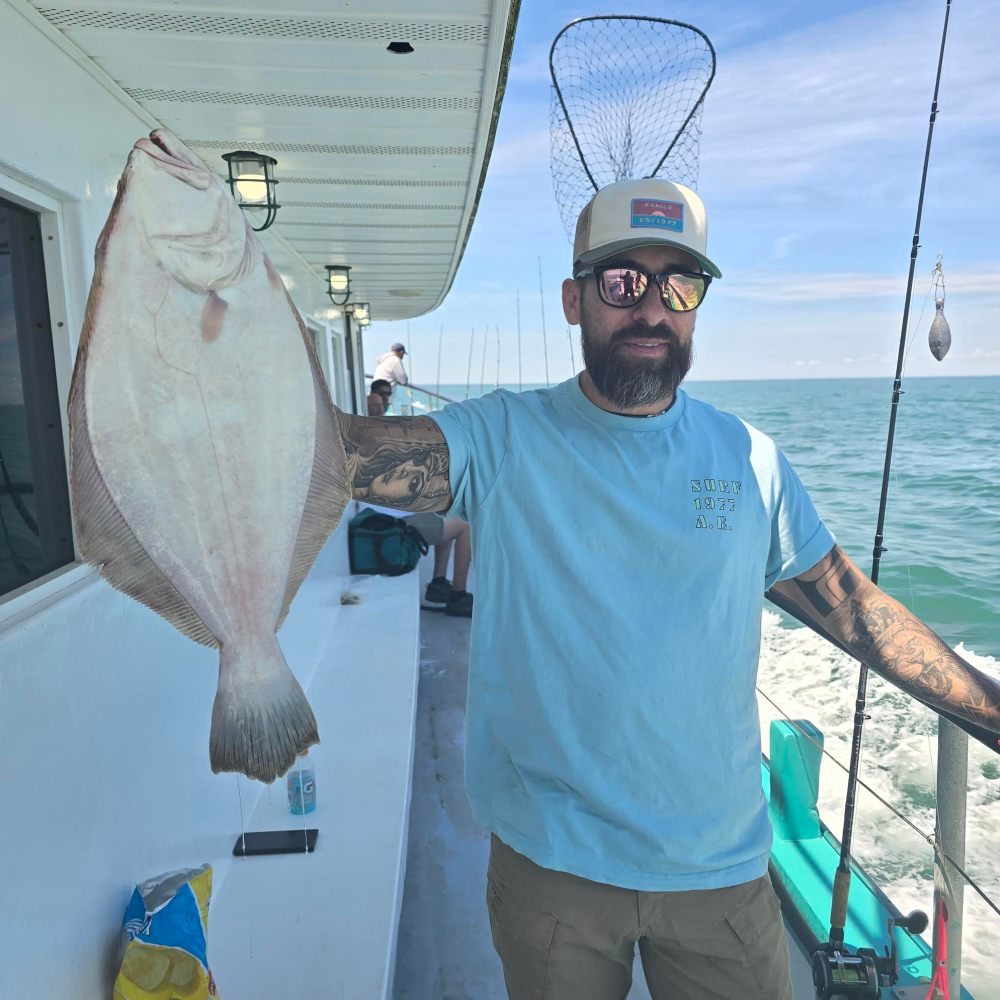 a man holding a fish in the water