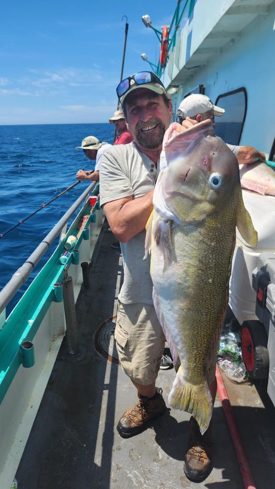 a man holding a fish in the water