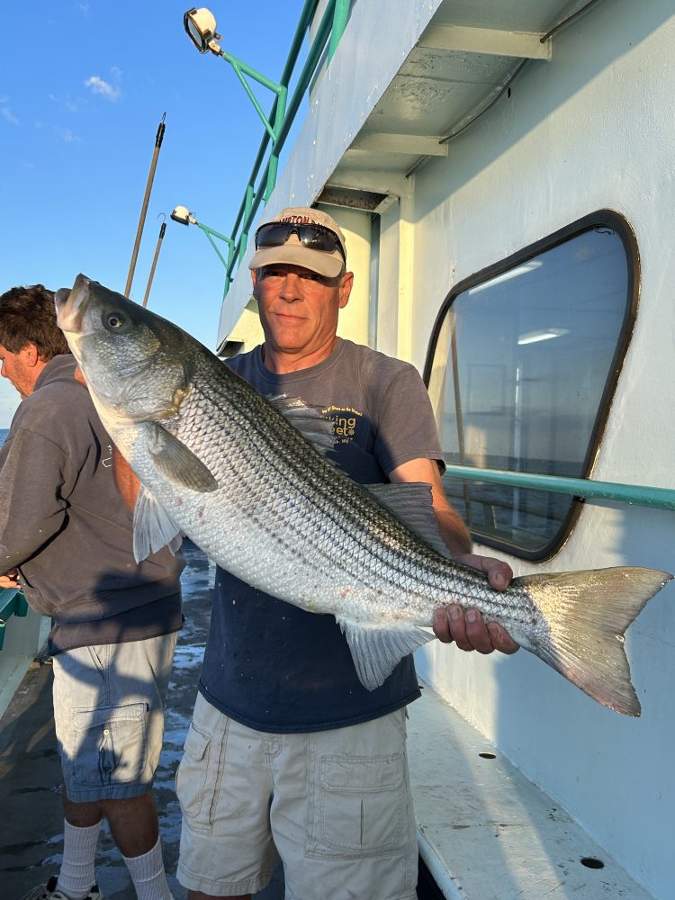 a man holding a fish