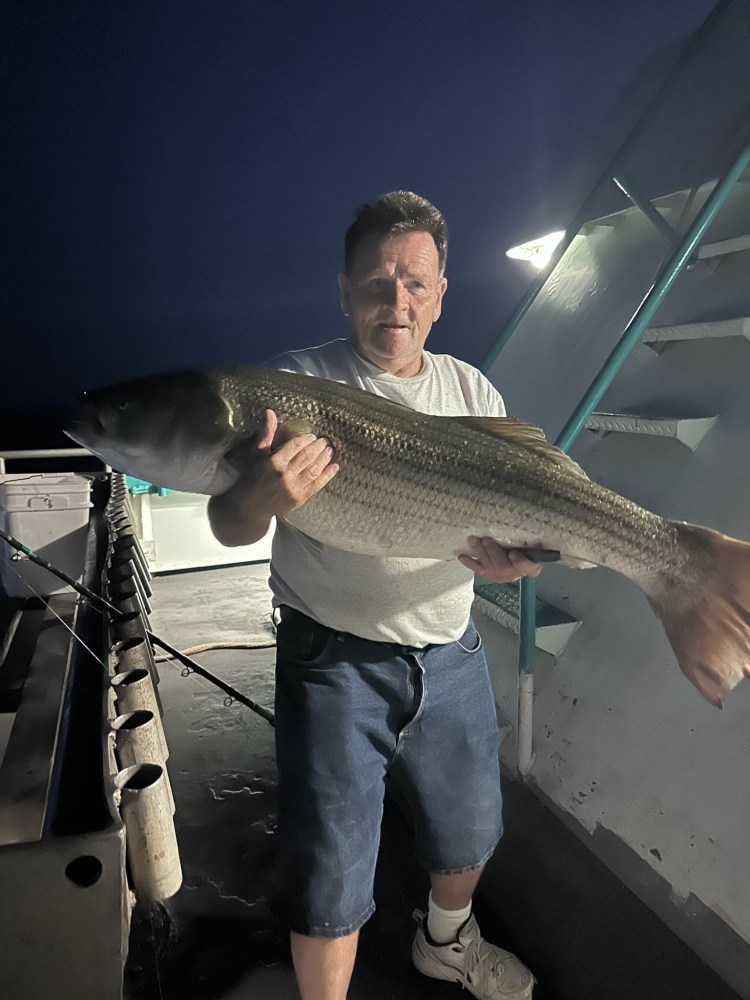 a man holding a fish