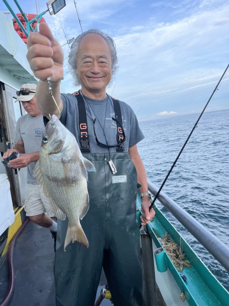 a person holding a fish on a boat