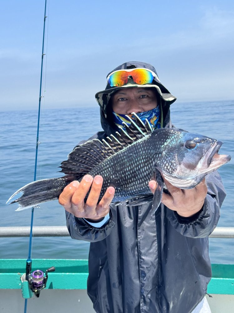 a person holding a fish in the water