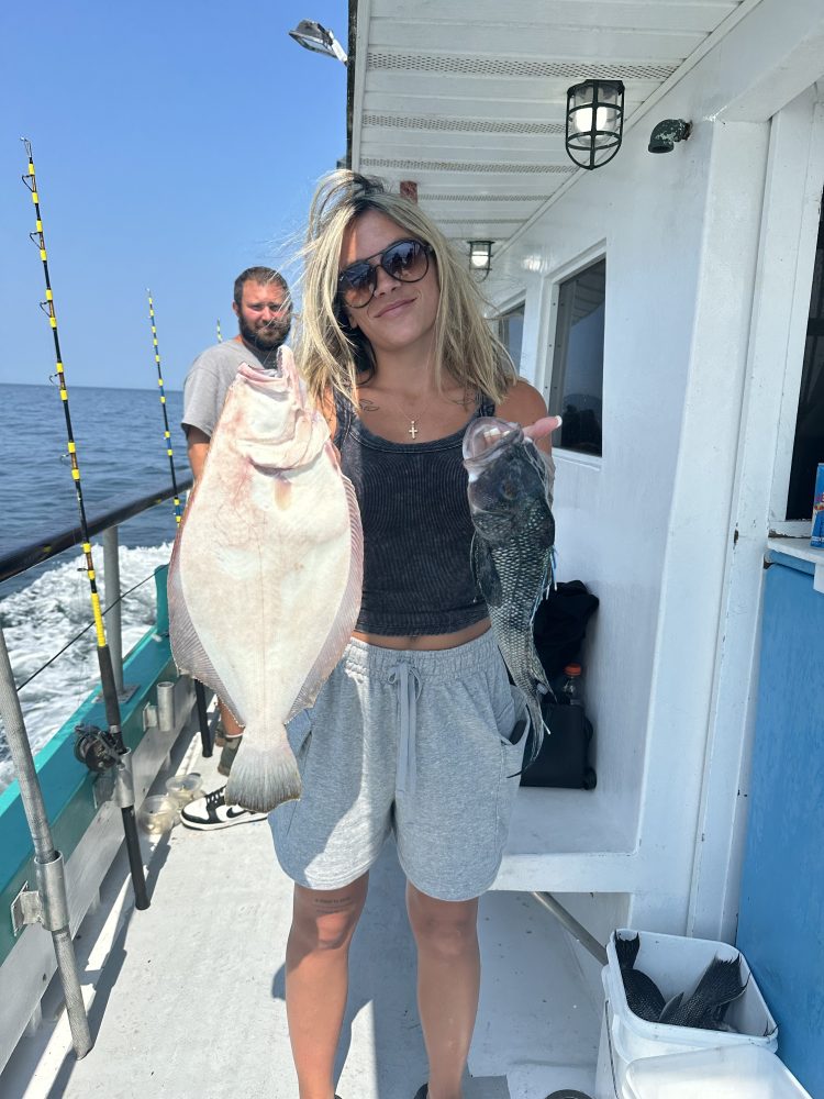 a woman holding a fish