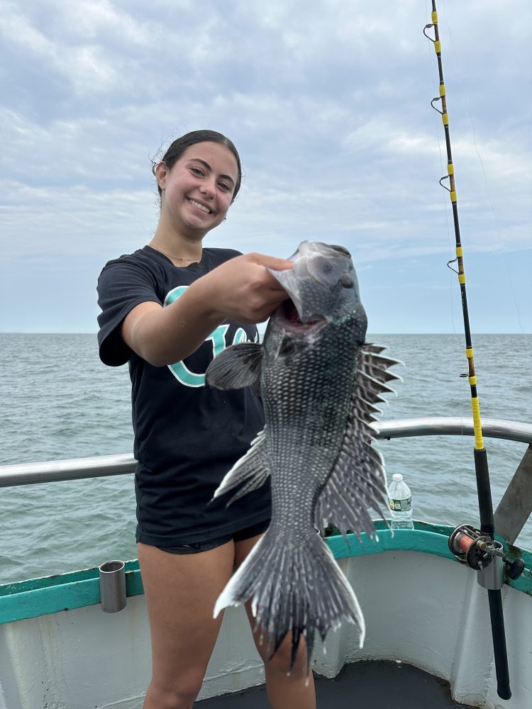 a woman holding a fish in the water