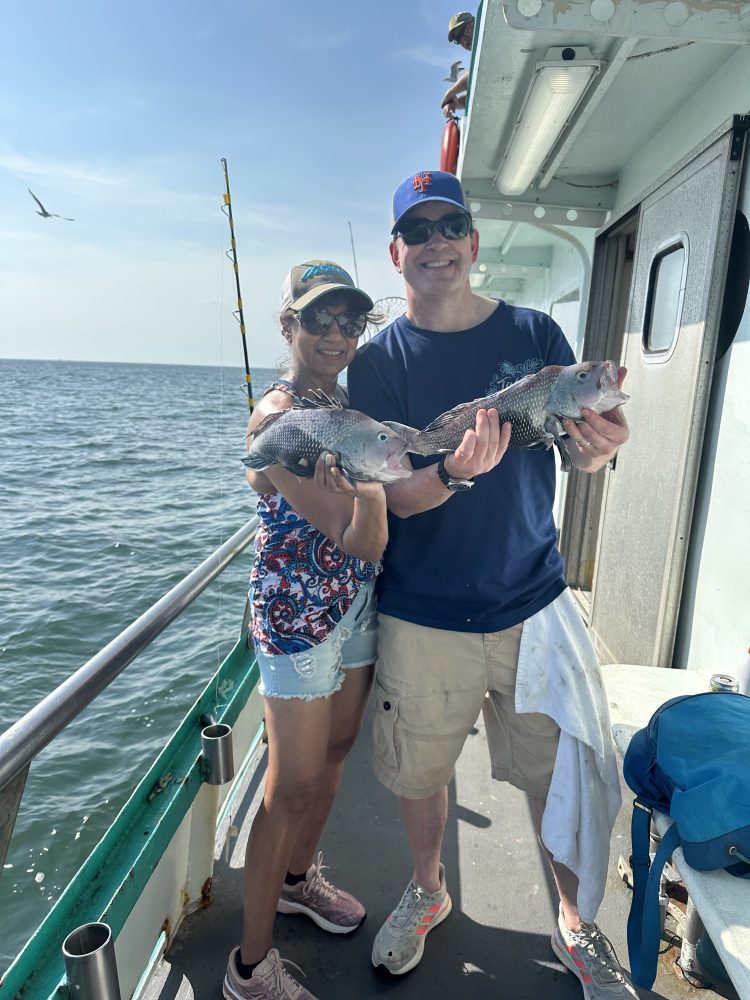 a person holding a fish on a boat