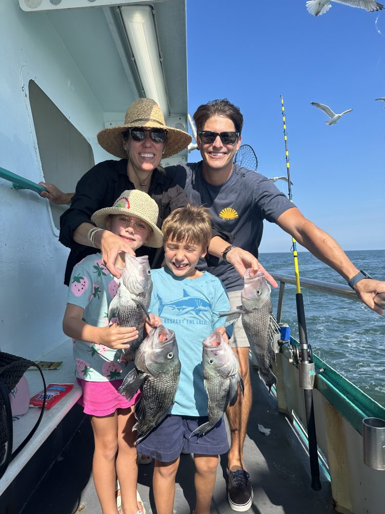 a person holding a fish on a boat